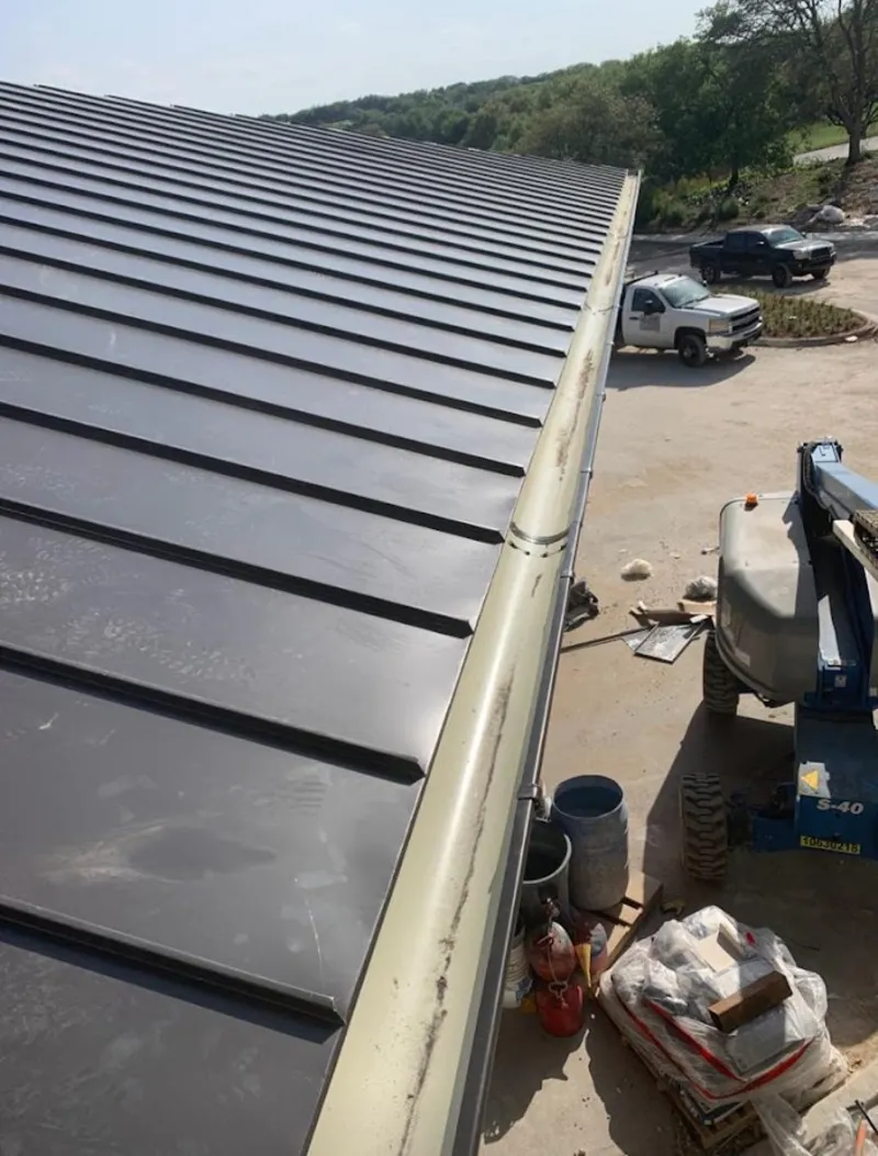 Standing seam panel and gutter detail on a metal roofing jobsite in Plymouth